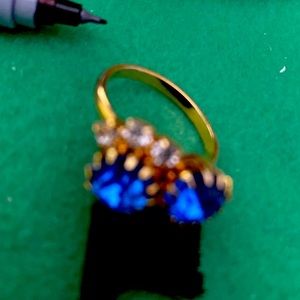 Blue stones and rhine stones in gold setting.  Size adjustable
